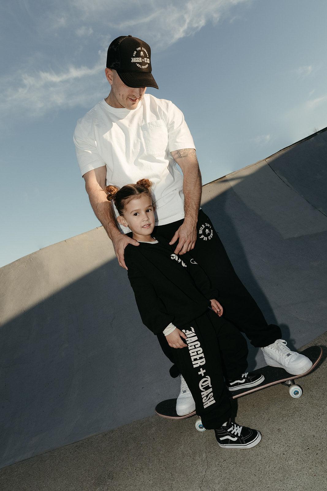 For the Sinners + Believers Adult Trucker Hat Jagger + Cash